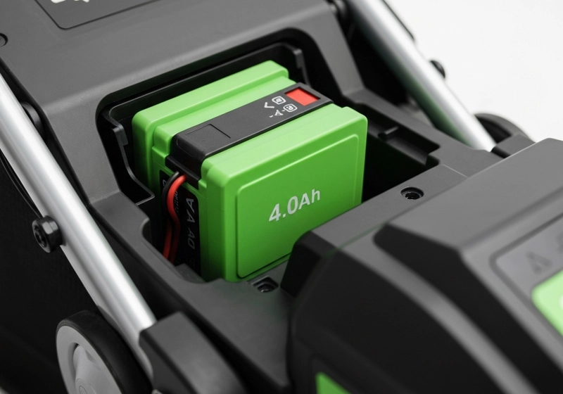 High-capacity lithium battery being installed in electric lawn mower