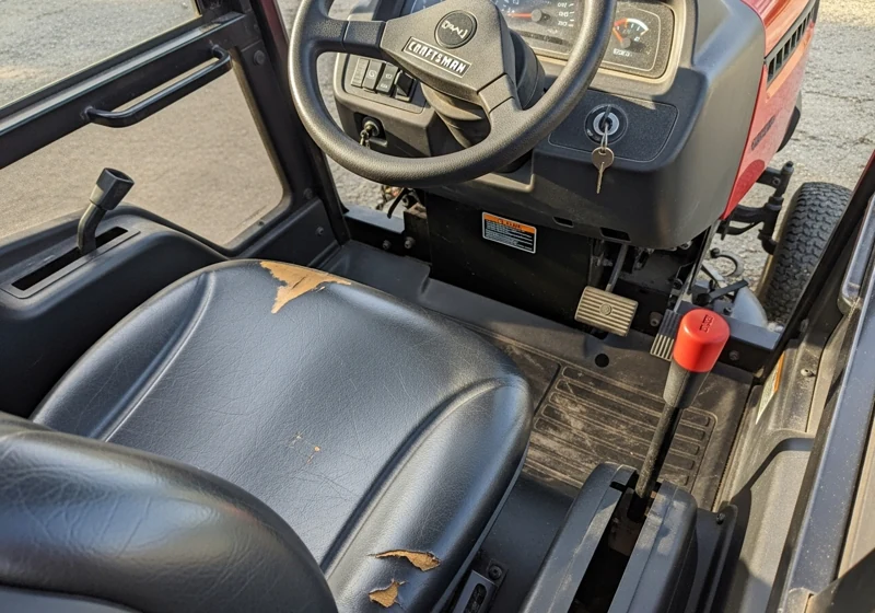 Craftsman YT3000 riding mower controls showing steering wheel and simple operation panel
